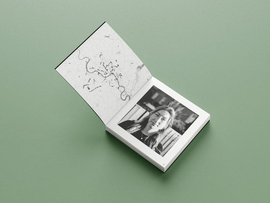 Open book with black and white photograph on a green background