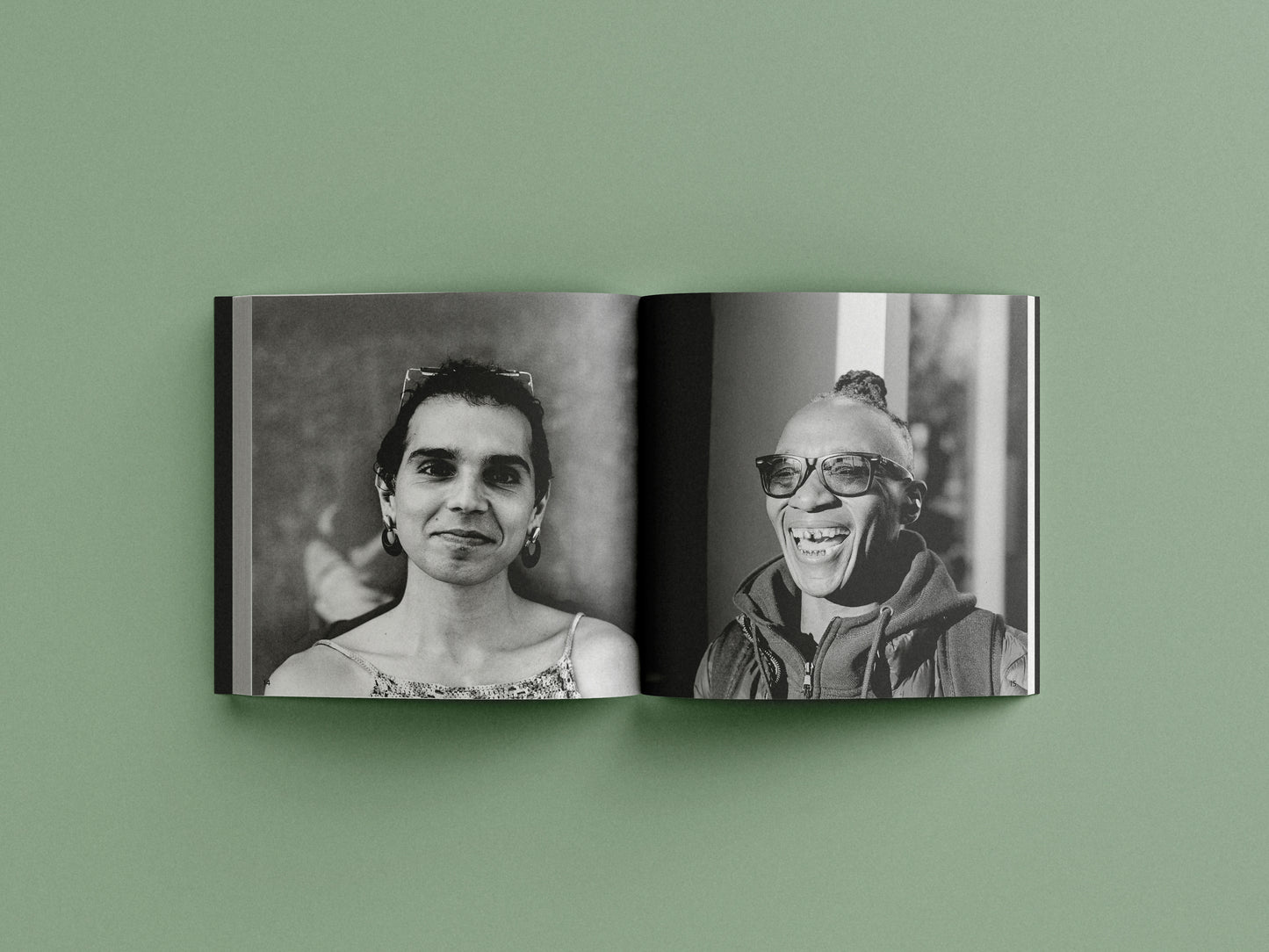 Open book showing black and white portraits on a green background