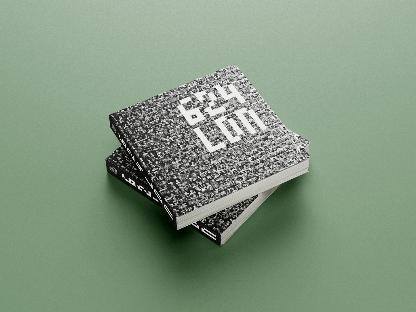 Two textured books stacked on a green background