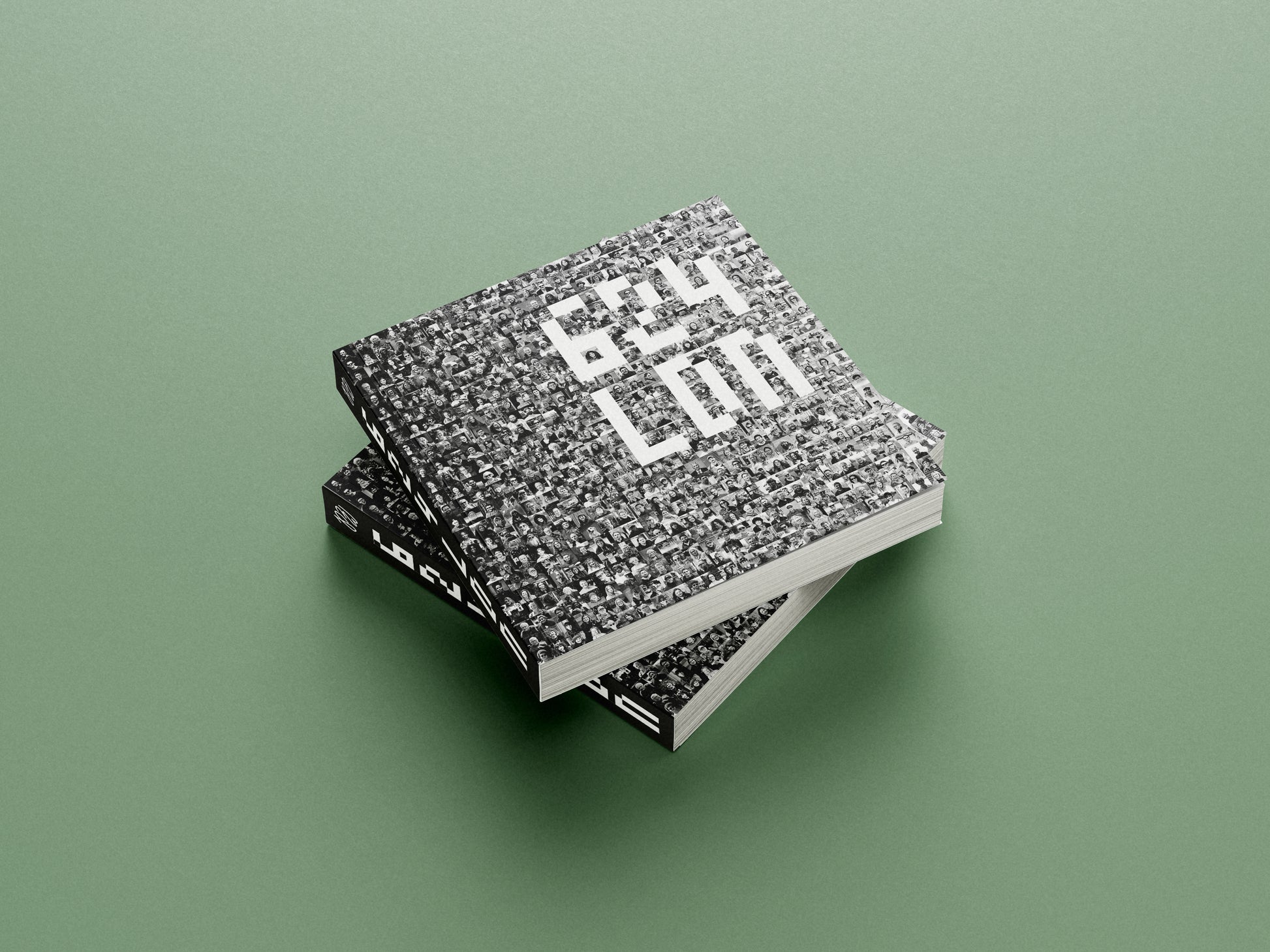 Two textured books stacked on a green background